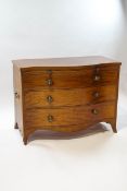 A George III mahogany serpentine chest of three drawers with a brushing slide,