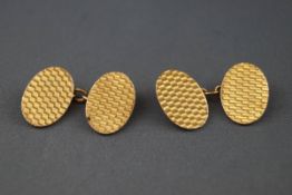 A pair of 9ct gold engine-turned oval twin panel cufflinks, Birmingham 1928,