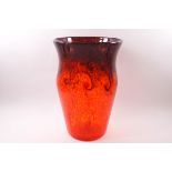 A Strathearn glass vase with aventurine and deep orange mottled swirl design on an orange ground,