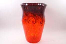 A Strathearn glass vase with aventurine and deep orange mottled swirl design on an orange ground,