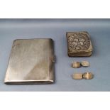 A silver cigarette case, with engine turned decoration,