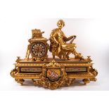 A large French gilt metal mantel clock with painted porcelain dial and panels,