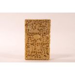 A 19th century Chinese carved ivory card case, overall decorated with figures, Pagodas and trees,