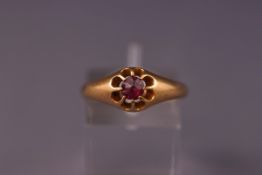 An early 20th century rose gold and small round garnet gypsy ring, indistinct hallmarks, size Q 1/2,