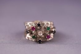 A set of five stacker rings gemset with emeralds, rubies and sapphires. Tests indcate 9ct gold.