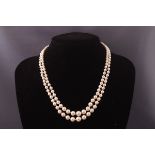 A double strand of graduated simulated pearls by Shima.