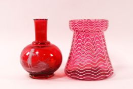 A mid 19th century cranberry glass vase with white wavy overlay,