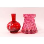 A mid 19th century cranberry glass vase with white wavy overlay,