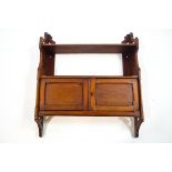 A set of Edwardian mahogany wall shelves with cupboard base, 72cm high x 61.