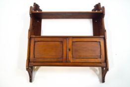 A set of Edwardian mahogany wall shelves with cupboard base, 72cm high x 61.