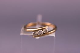 A yellow metal three stone ring set with three 3.00mm diamonds. hallmarked 9ct gold. Size: J 1/2.