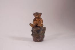 An Austrian cold painted bronze of a teddy bear sitting on a log, 4.