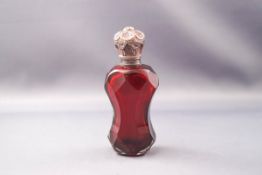 A Victorian red glass scent bottle and stopper, faceted body and silver plate hinged cover, 10.