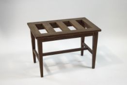 An oak luggage rack on square tapering legs linked by an "H" stretcher, 46cm high x 67cm wide x 40.