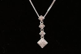 A 9ct white gold cubic zirconia pendant suspended on a filed curb chain together with a pair of 9ct