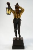 An unusual Continental table lamp, carved and painted in the form of a man holding a lantern,