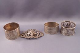 Three silver napkin rings, one with engine turned decoration,