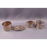 Three silver napkin rings, one with engine turned decoration,