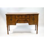 An Edwardian mahogany serpentine sideboard, two central drawers flanked by cuboards,