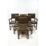 A set of six oak dining chairs with green leather upholstery and brass studding,