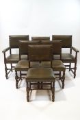 A set of six oak dining chairs with green leather upholstery and brass studding,