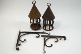 A pair of French iron chateau dungeon lanterns and brackets