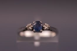 A white metal three stone sapphire and diamond ring. Size: I 1/2. Hallmarked 9ct gold. Weight: 1.