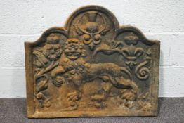 A cast iron fireback, cast with a lion, rose, thistle and fleur dy lys,