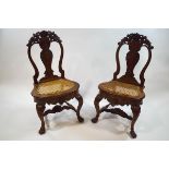 A pair of 19th century Indian hardwood chairs with cane seats,