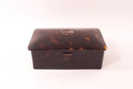An early 20th century rectangular tortoiseshell box with silver hinges,