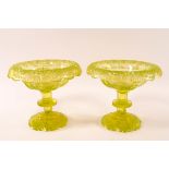 A pair of Victorian uranium cut glass bowls on flared stems and shaped cut glass feet,