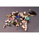 A collection of loose gemstones to include a large oval banded agate, a moss agate, cameo's, quartz,