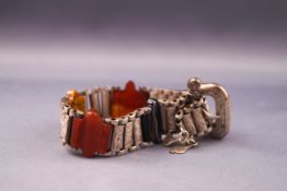 A Scottish bracelet stylized as a belt consisting of cut agate links with engraved finish to silver.