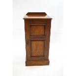 A Victorian mahogany pot cupboard, the panelled door enclosing a single shelf,