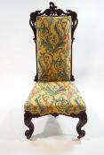 A Victorian rosewood chair with elaborately carved frame and legs
