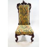 A Victorian rosewood chair with elaborately carved frame and legs