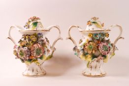 A pair of late 19th/early 20th century porcelain two handled vases and covers,