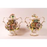 A pair of late 19th/early 20th century porcelain two handled vases and covers,