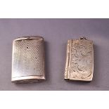 A silver vesta case in the form of a book, with hinged cover engraved scrolling foliage, 5.