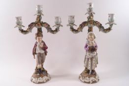 A pair of Continental Sitzendorf style porcelain three branch candelabra,