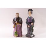 Two Japanese earthenware nodding head figures of women,