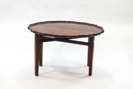 A George III style mahogany coaching table with piecrust edge to the top, on square tapering legs,