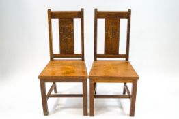A pair of oak Church chairs with solid seats and square legs,