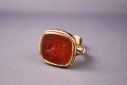 A yellow metal seal fob with carnelian seal. Tests indicate 9ct gold. 13.