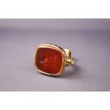 A yellow metal seal fob with carnelian seal. Tests indicate 9ct gold. 13.