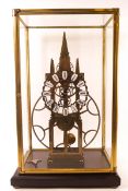 A long duration Great Wheel skeleton clock, in a glazed clock on plinth base with glass case,