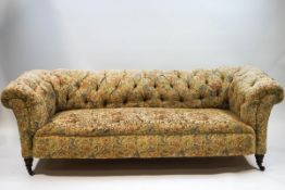 A Victorian Chesterfield sofa with button back, on turned legs with ceramic casters,