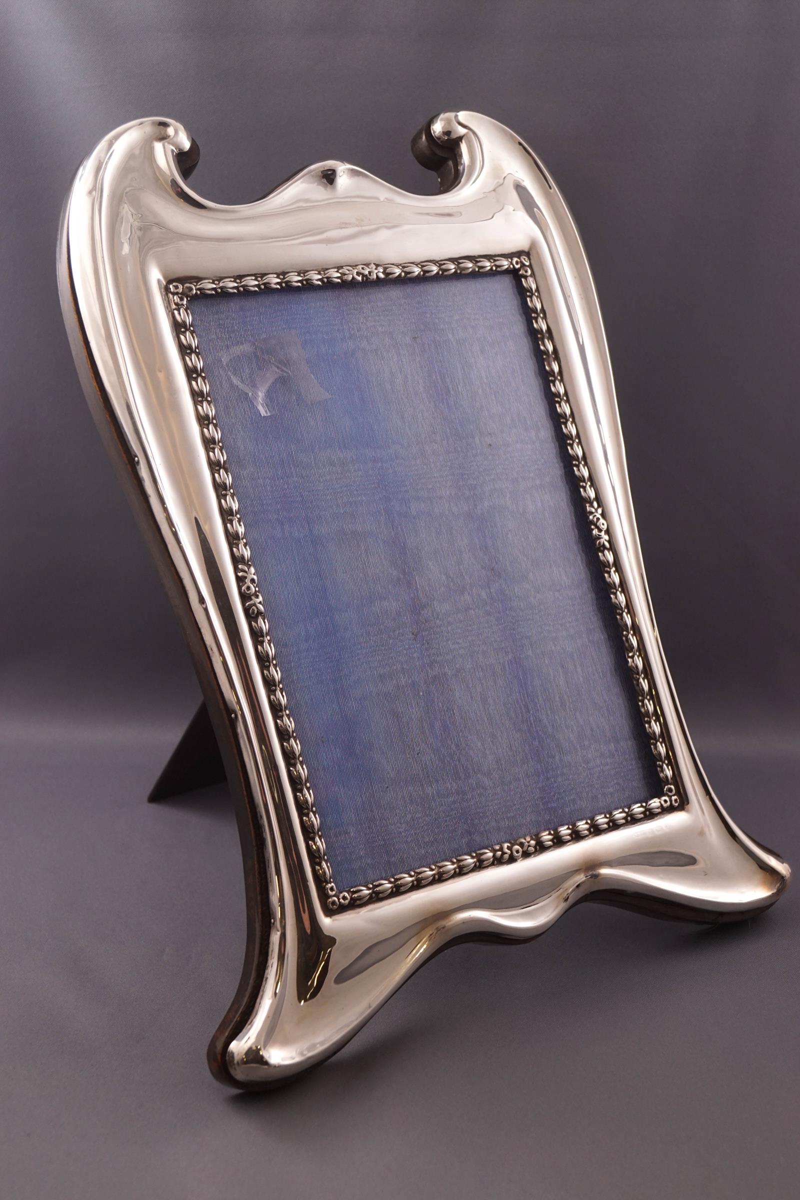 A large silver art nouveau style photograph frame, 31cm x 23cm,