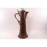 An Art nouveau style copper jug with brass finial, handle and pierced foot, 40.