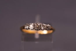 A yellow and white metal graduated five stone old cut diamond ring.